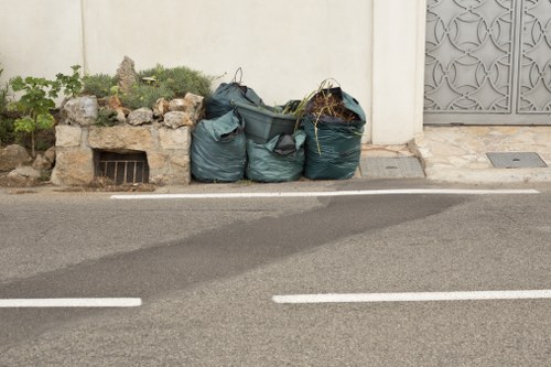 A professional clearing garden debris in Bermondsey